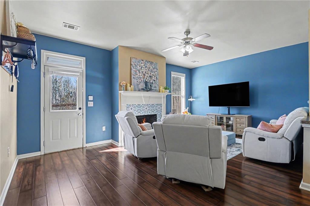 404 East Gate Trail Ball Ground, GA 30107 - Photo 13 of 25 a living room with furniture a fireplace and a flat screen tv