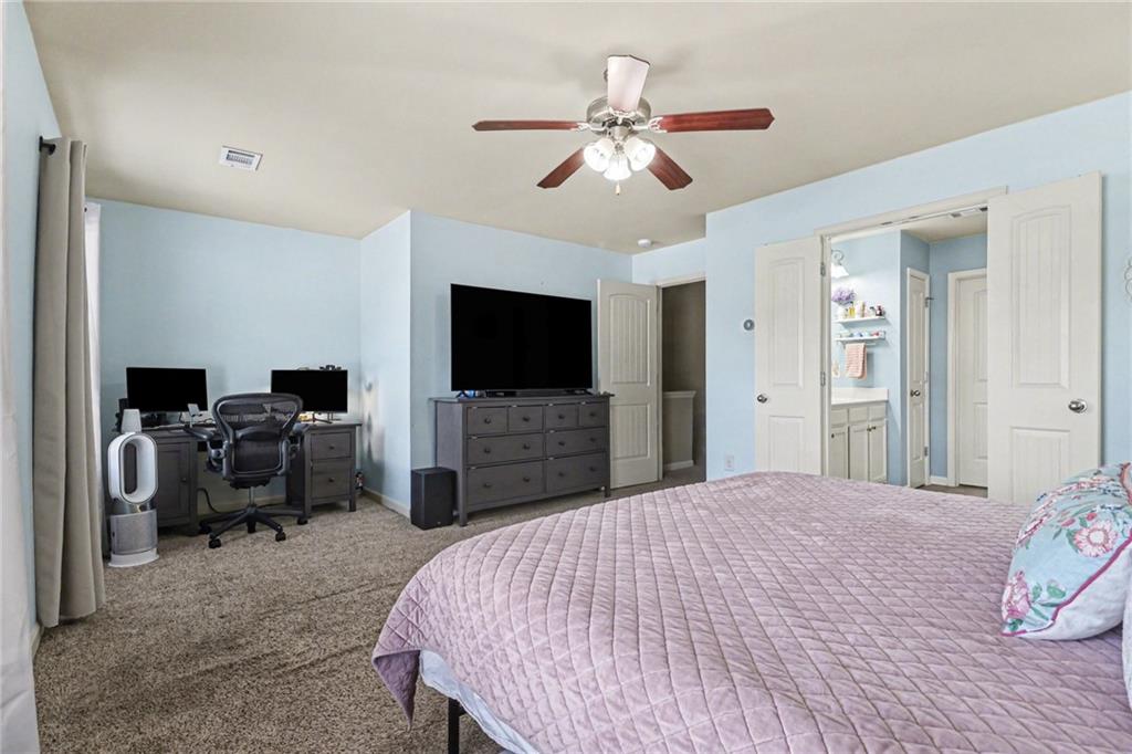 404 East Gate Trail Ball Ground, GA 30107 - Photo 16 of 25 a bedroom with a bed and a flat screen tv