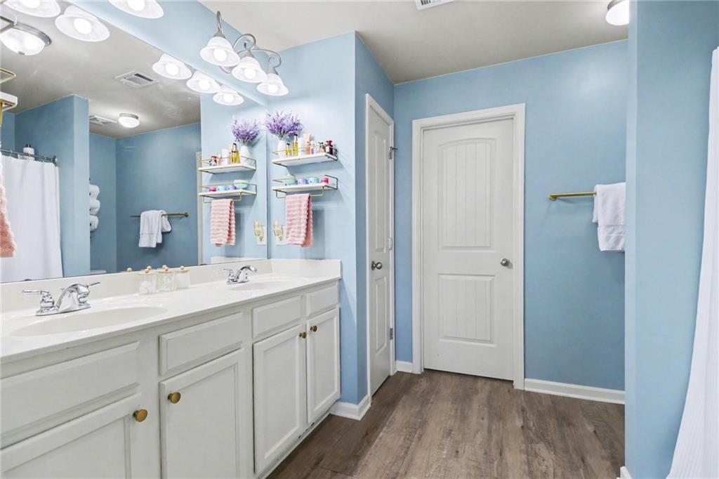 404 East Gate Trail Ball Ground, GA 30107 - Photo 17 of 25 a spacious bathroom with a shower sink and a mirror