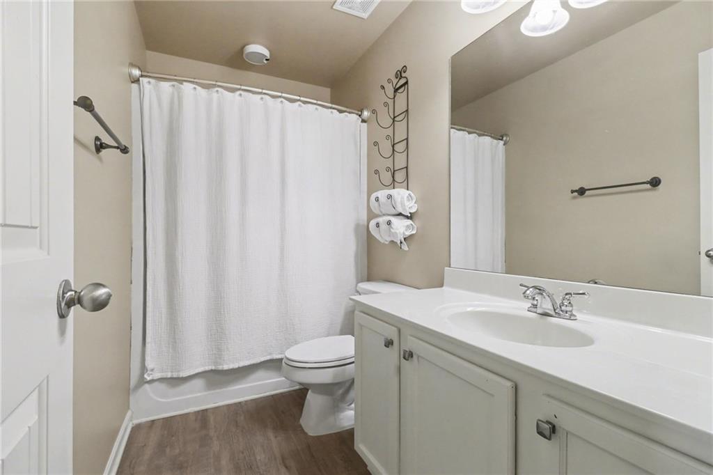 404 East Gate Trail Ball Ground, GA 30107 - Photo 18 of 25 a bathroom with a granite countertop sink toilet and shower