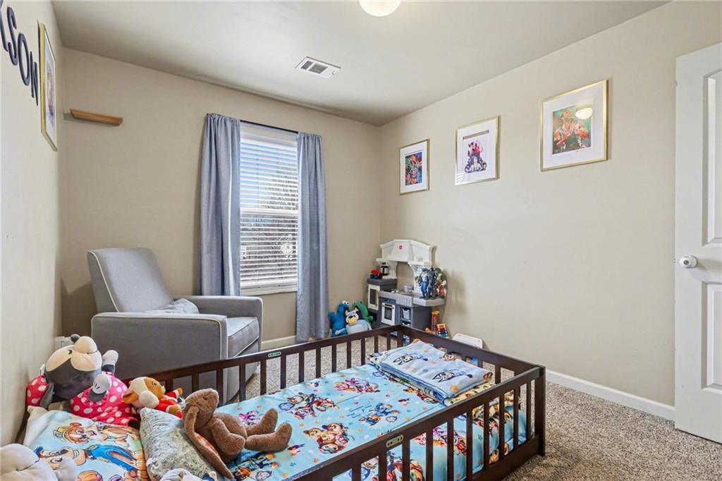 404 East Gate Trail Ball Ground, GA 30107 - Photo 19 of 25 a bedroom with a bed and a window