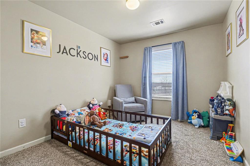 404 East Gate Trail Ball Ground, GA 30107 - Photo 20 of 25 a bedroom with furniture and a window