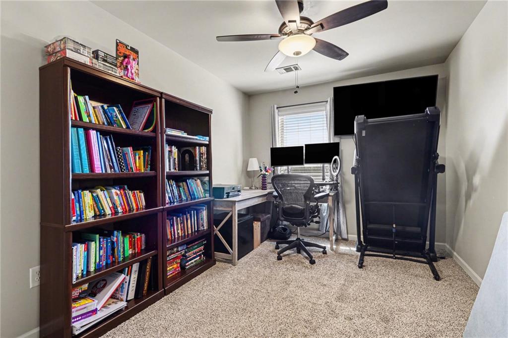 404 East Gate Trail Ball Ground, GA 30107 - Photo 21 of 25 a view of a workspace with bookshelf