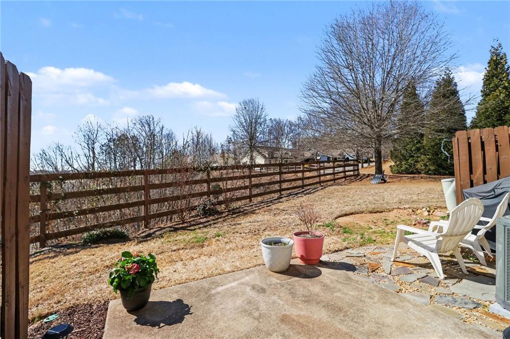 404 East Gate Trail Ball Ground, GA 30107 - Photo 23 of 25 a view of a terrace with a bench