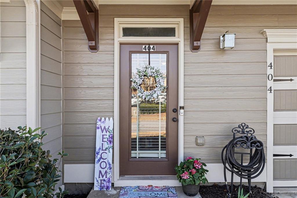 404 East Gate Trail Ball Ground, GA 30107 - Photo 4 of 25 a front view of a house with potted plants