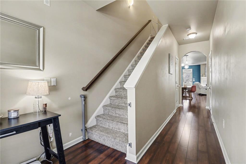 404 East Gate Trail Ball Ground, GA 30107 - Photo 6 of 25 a view of a hallway with wooden floor and staircase
