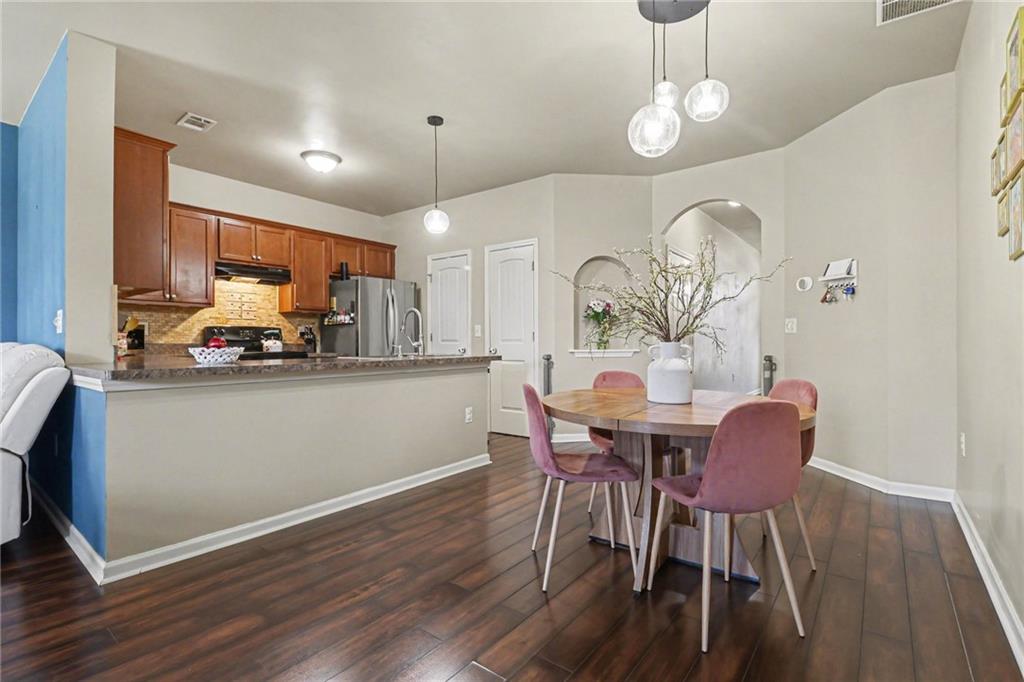 404 East Gate Trail Ball Ground, GA 30107 - Photo 8 of 25 a view of a dining room with furniture and wooden floor