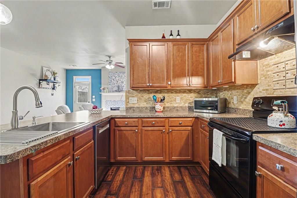 404 East Gate Trail Ball Ground, GA 30107 - Photo 10 of 25 a kitchen with stainless steel appliances granite countertop a sink stove and cabinets