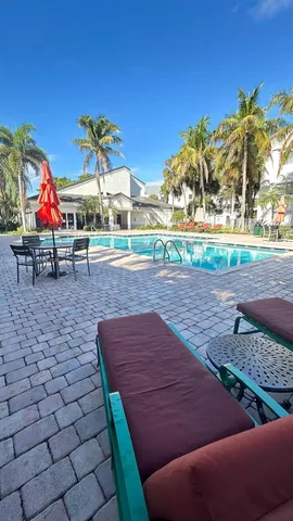 a pathway to a building with a yard