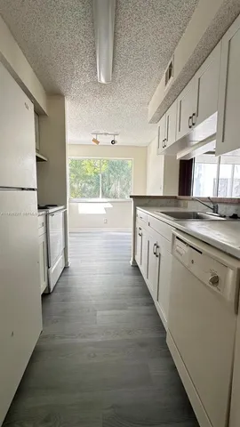 a kitchen with stainless steel appliances a stove sink and cabinets