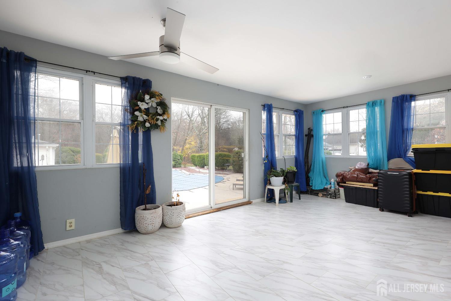 92 Main Street Helmetta, NJ 08828 - Photo 17 of 57 a living room with furniture large windows and a chandelier