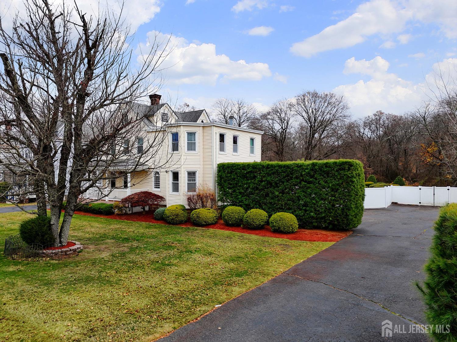 92 Main Street Helmetta, NJ 08828 - Photo 39 of 57 a view of a white house that has a large tree in front of it