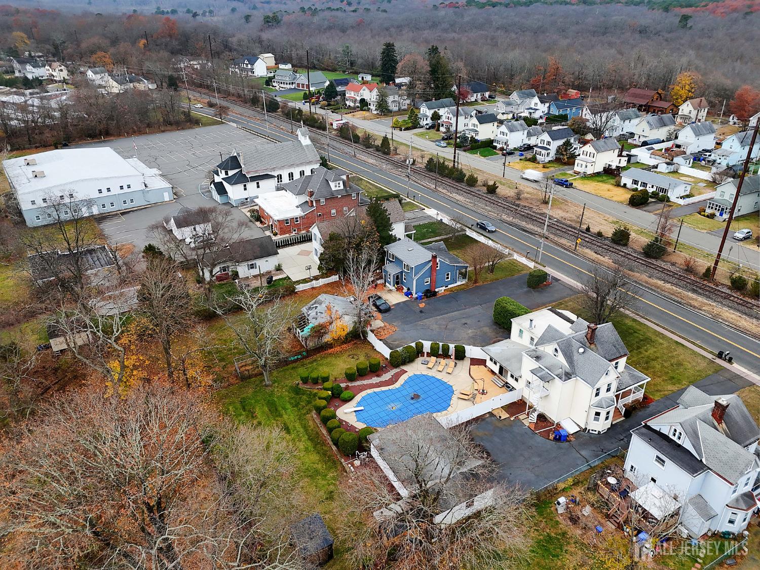 92 Main Street Helmetta, NJ 08828 - Photo 48 of 57 an aerial view of a house with a swimming pool yard and mountain view