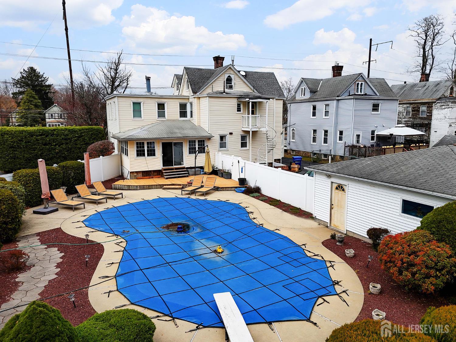 92 Main Street Helmetta, NJ 08828 - Photo 55 of 57 a view of a patio with couches chairs and a fire pit with an outdoor space