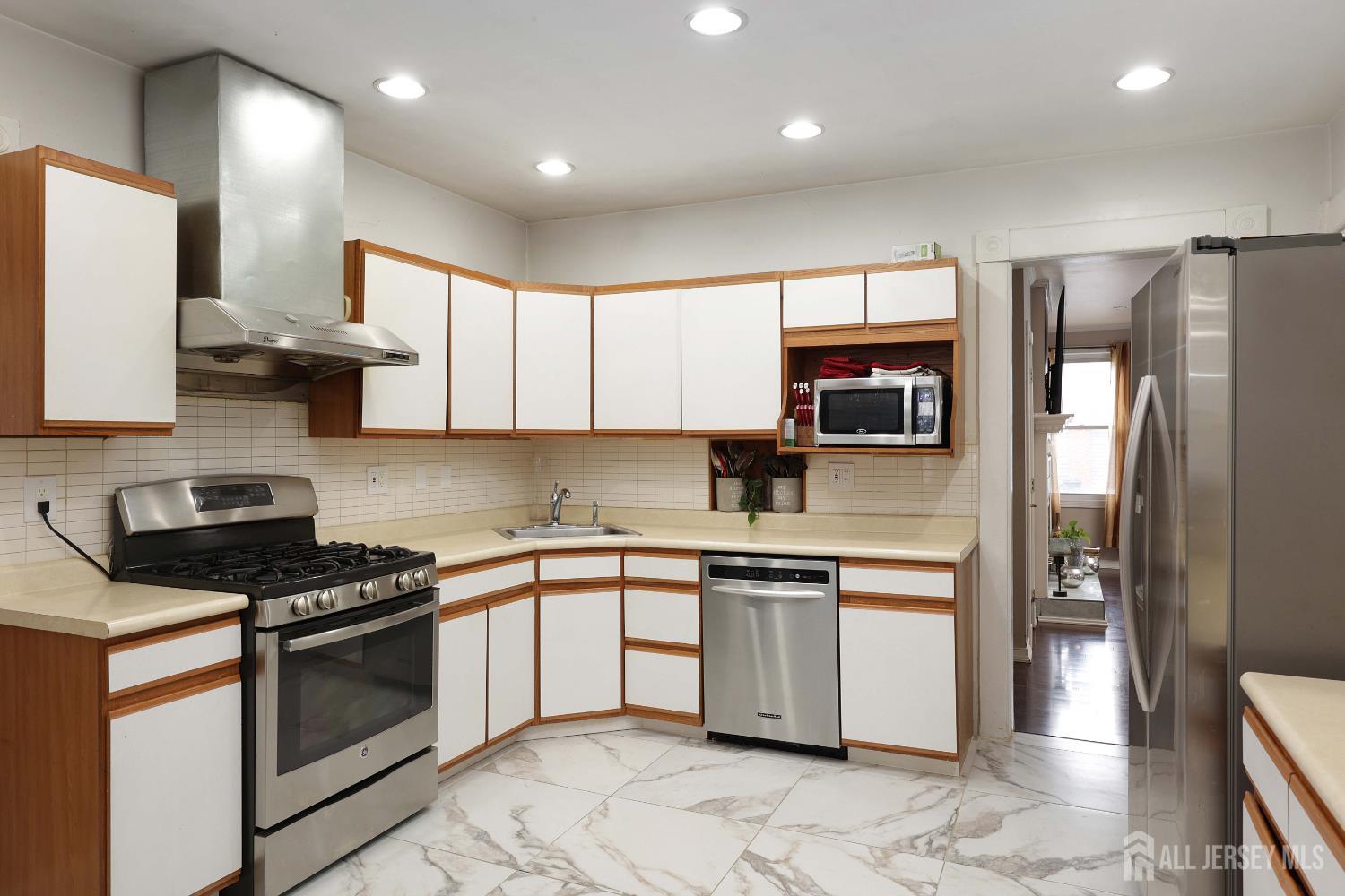 92 Main Street Helmetta, NJ 08828 - Photo 9 of 57 a kitchen with stainless steel appliances granite countertop a stove a sink and a refrigerator