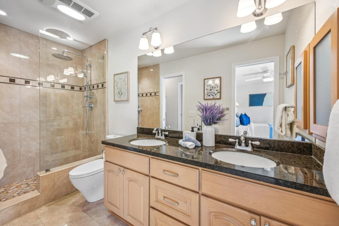94 Flynn Avenue, Unit D Mountain View, CA 94043 - Photo 15 of 21 a bathroom with a granite countertop double vanity sink mirror bathtub shower and toilet