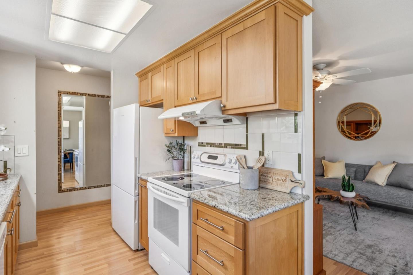 94 Flynn Avenue, Unit D Mountain View, CA 94043 - Photo 4 of 21 a kitchen with stainless steel appliances granite countertop a sink and a refrigerator
