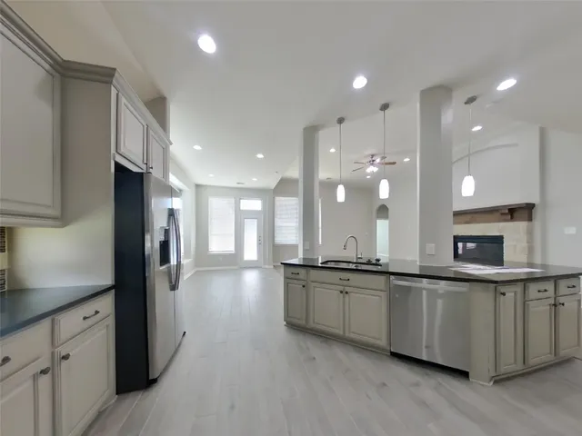 a large kitchen with stainless steel appliances lots of counter space and a sink