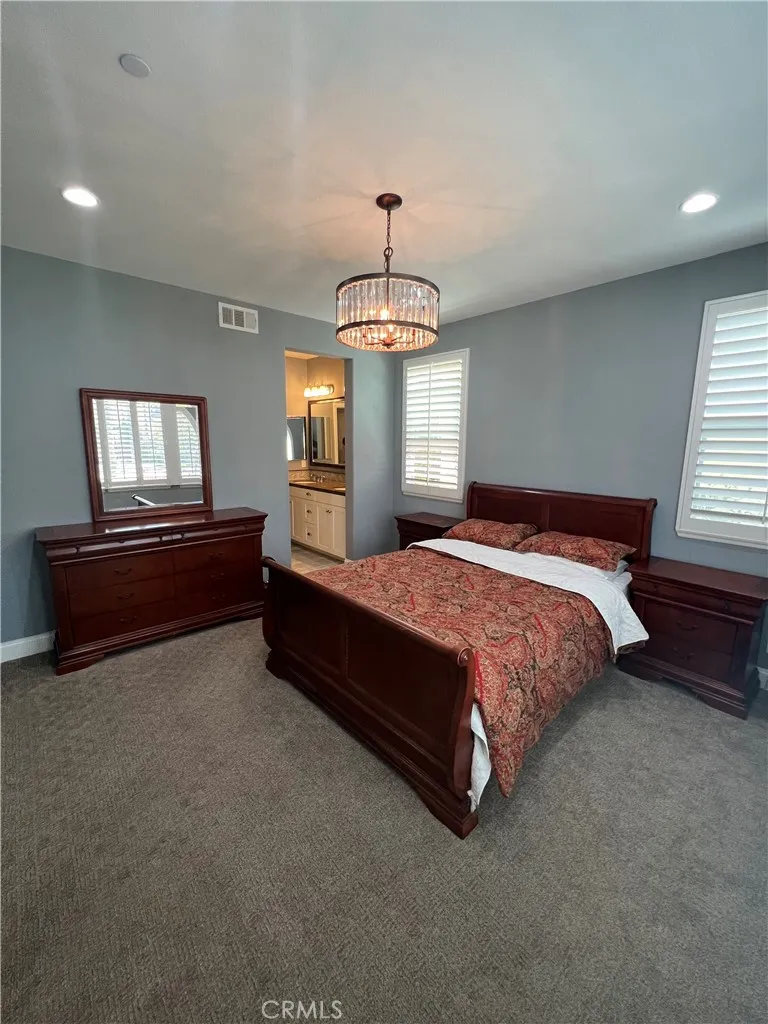 406 Sevilla Drive Brea, CA 92823 - Photo 9 of 33 a spacious bedroom with a bed and a chandelier