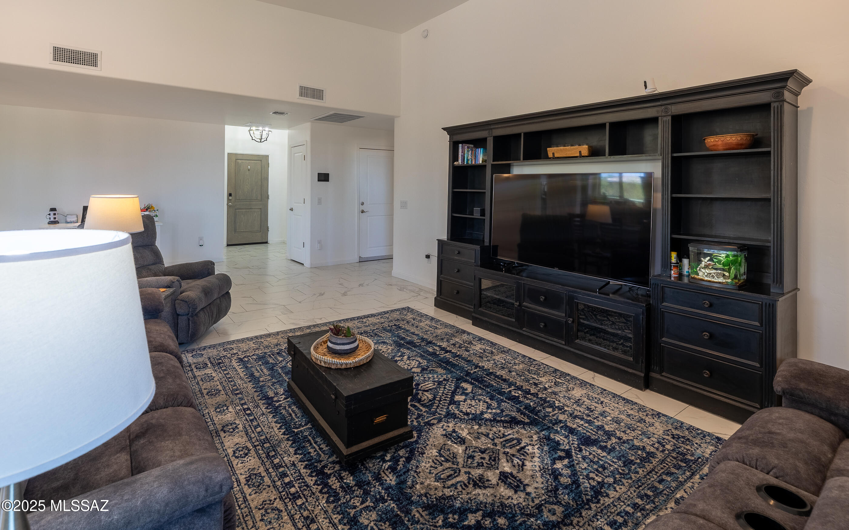 12123 Creosote Valley Road Vail, AZ 85641 - Photo 7 of 46 a living room with furniture and a flat screen tv