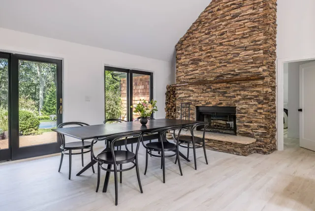 a dining room with furniture and a fireplace