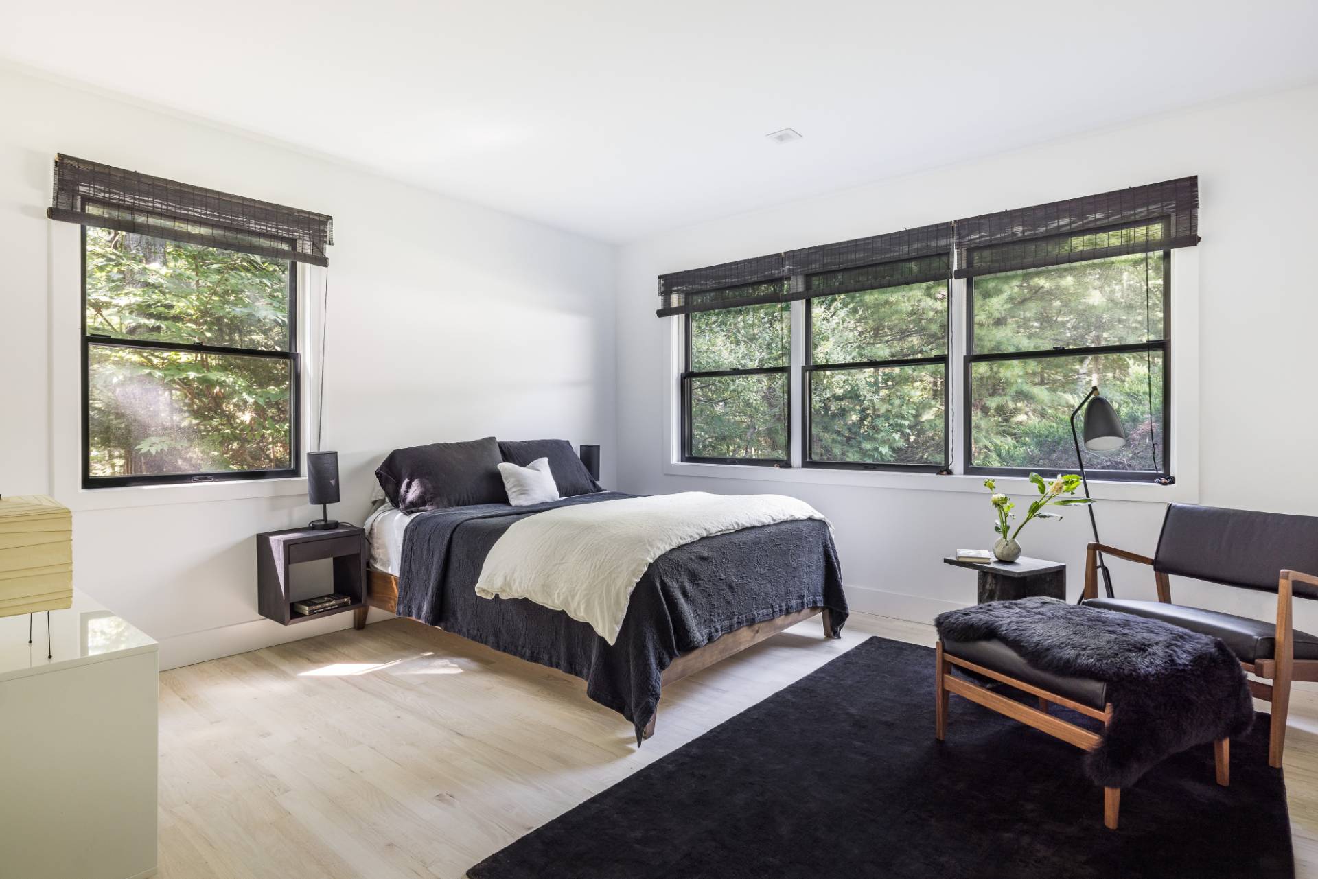 163 Talmage Farm Lane East Hampton, NY 11937 - Photo 14 of 19 a bedroom with a bed and wooden floor