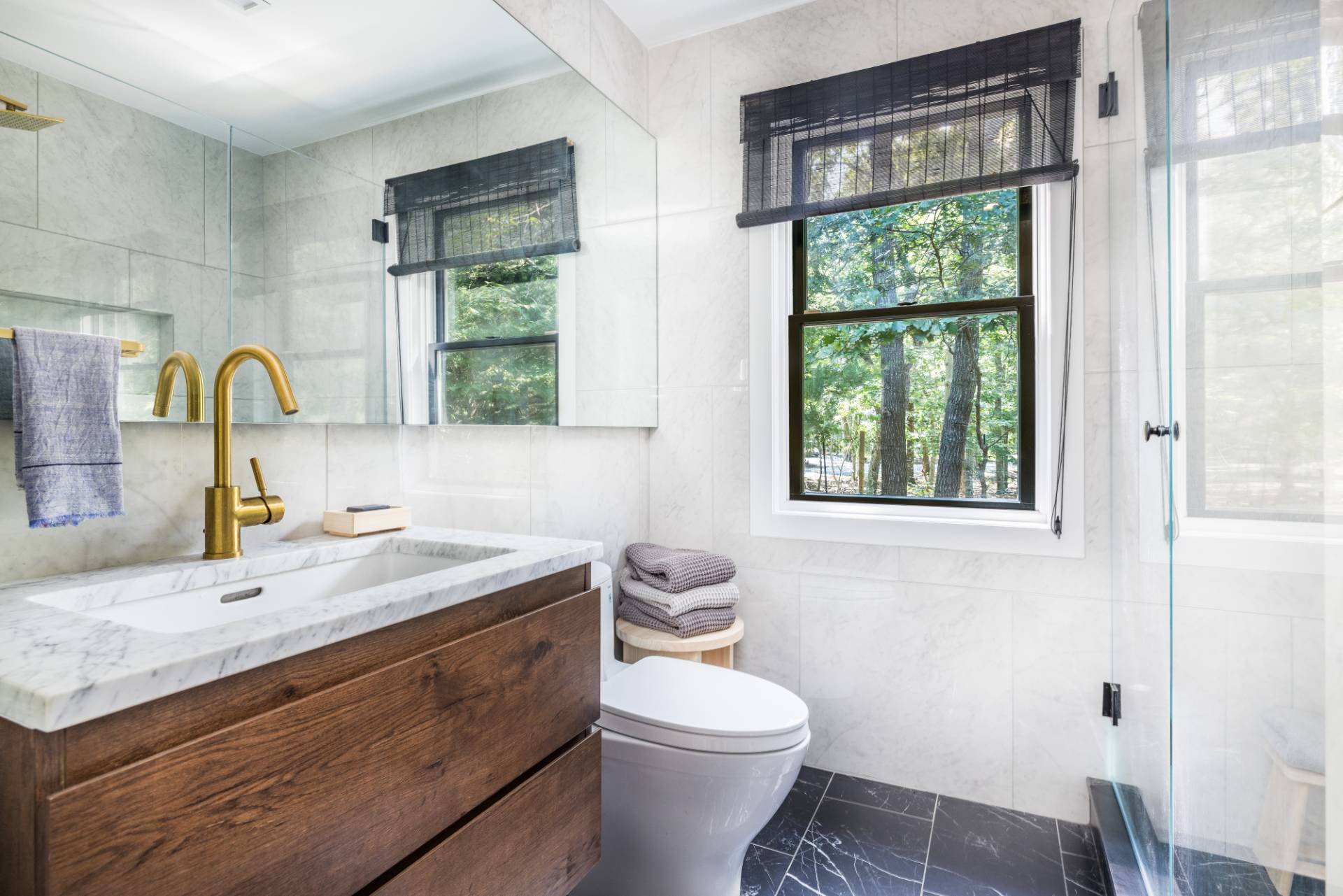 163 Talmage Farm Lane East Hampton, NY 11937 - Photo 16 of 19 a bathroom with a granite countertop toilet a sink and a window