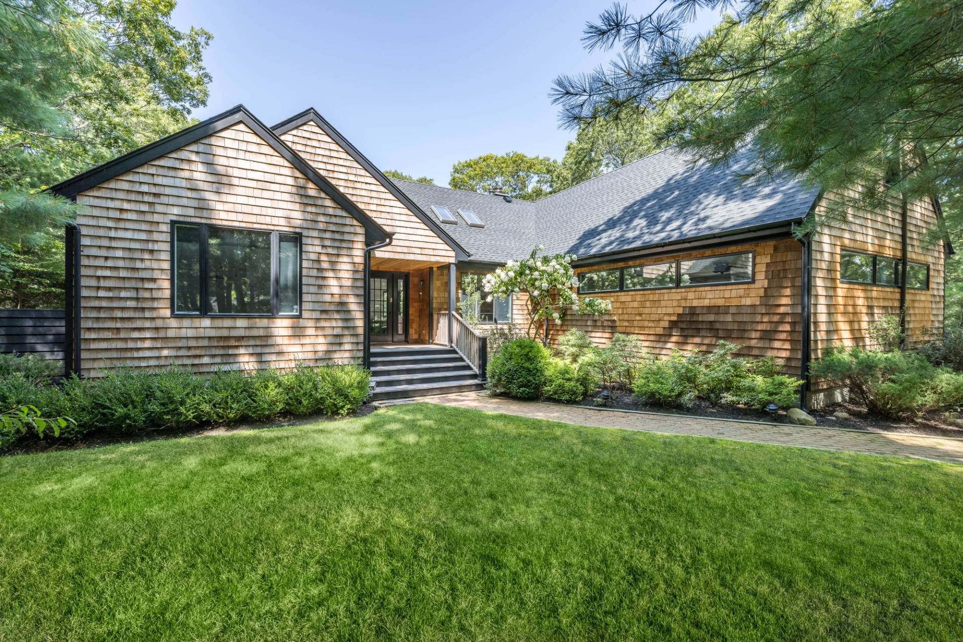 163 Talmage Farm Lane East Hampton, NY 11937 - Photo 18 of 19 a backyard of a house with plants and large tree