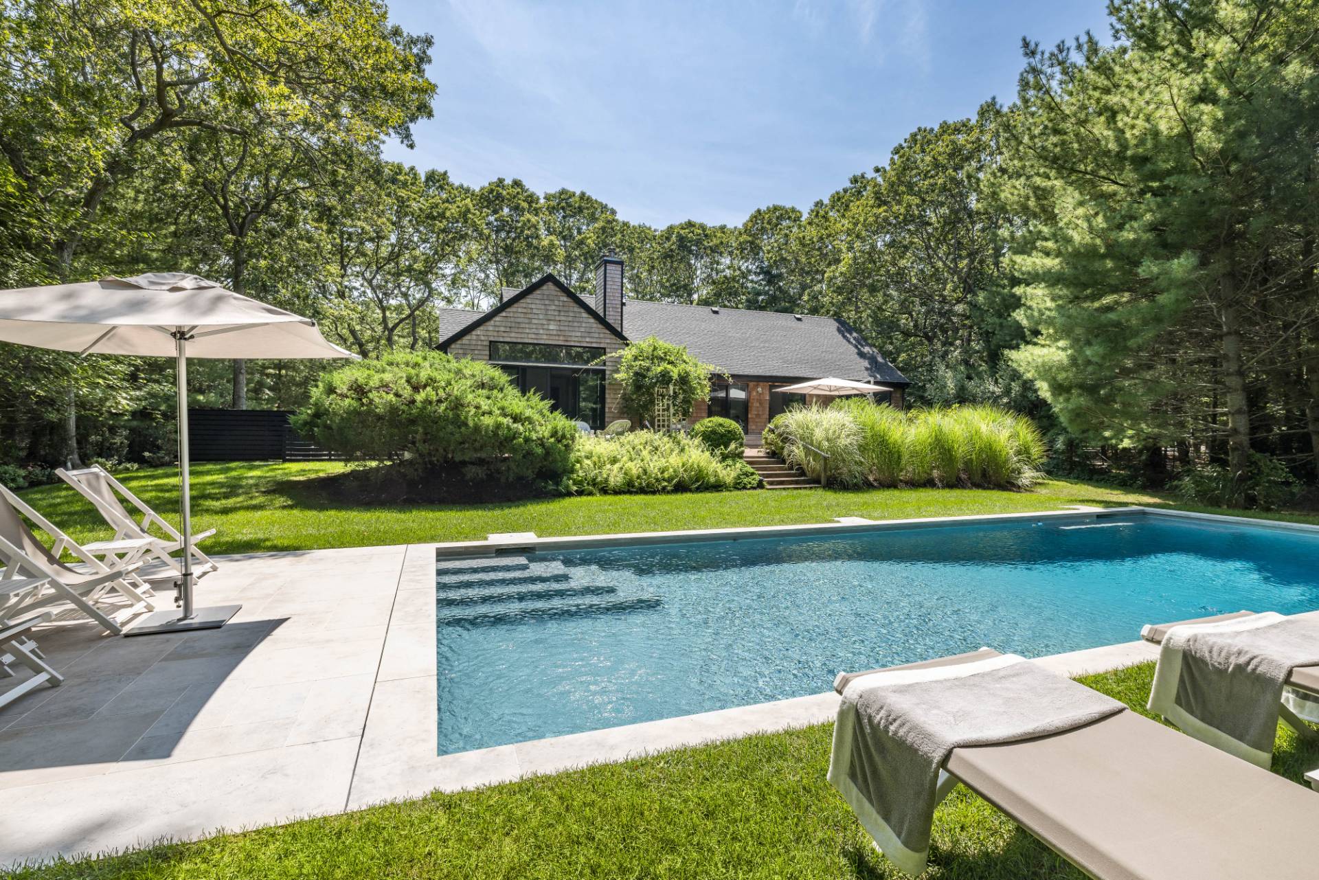 163 Talmage Farm Lane East Hampton, NY 11937 - Photo 2 of 19 a view of backyard with seating area and green space
