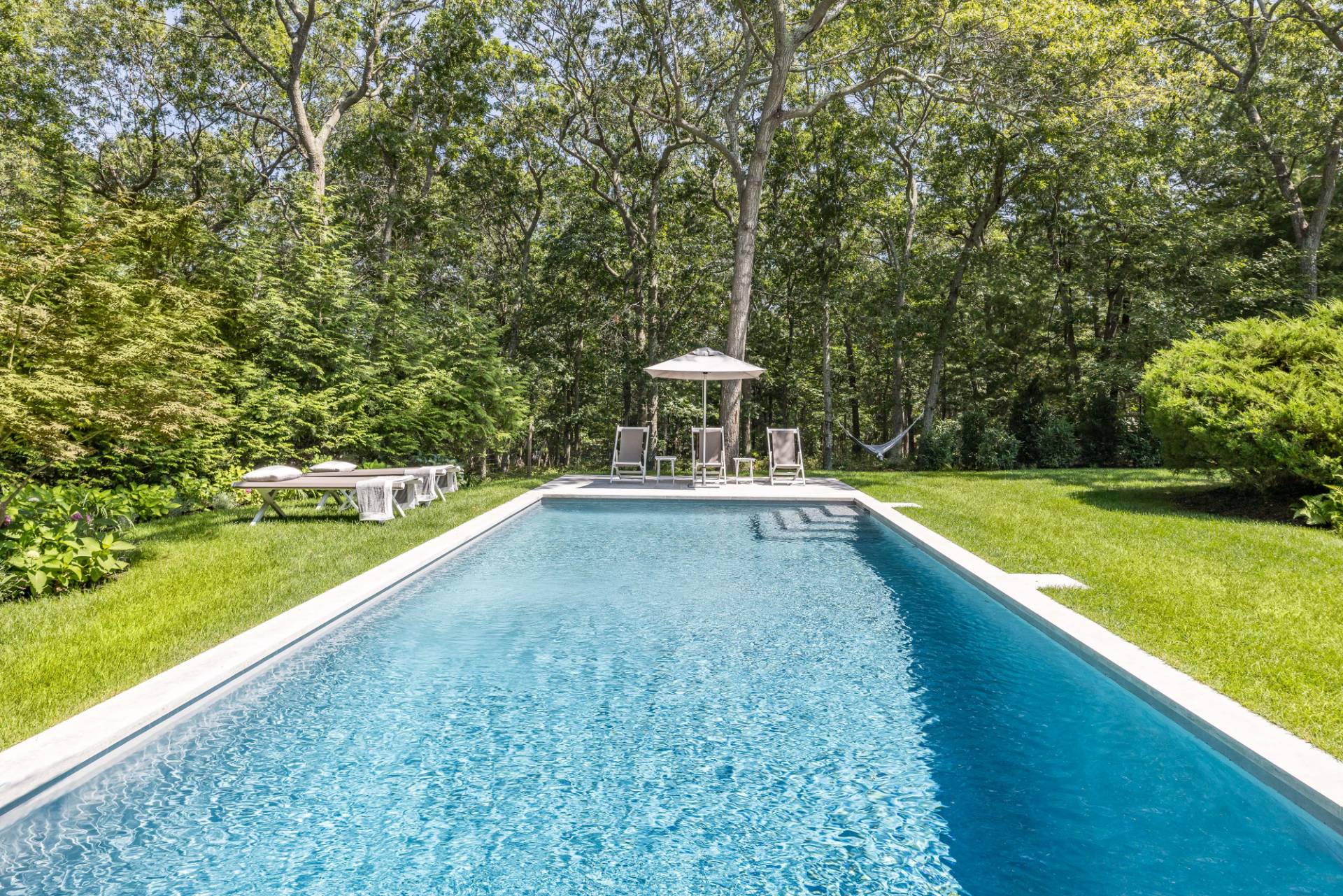 163 Talmage Farm Lane East Hampton, NY 11937 - Photo 3 of 19 a view of a swimming pool with a yard