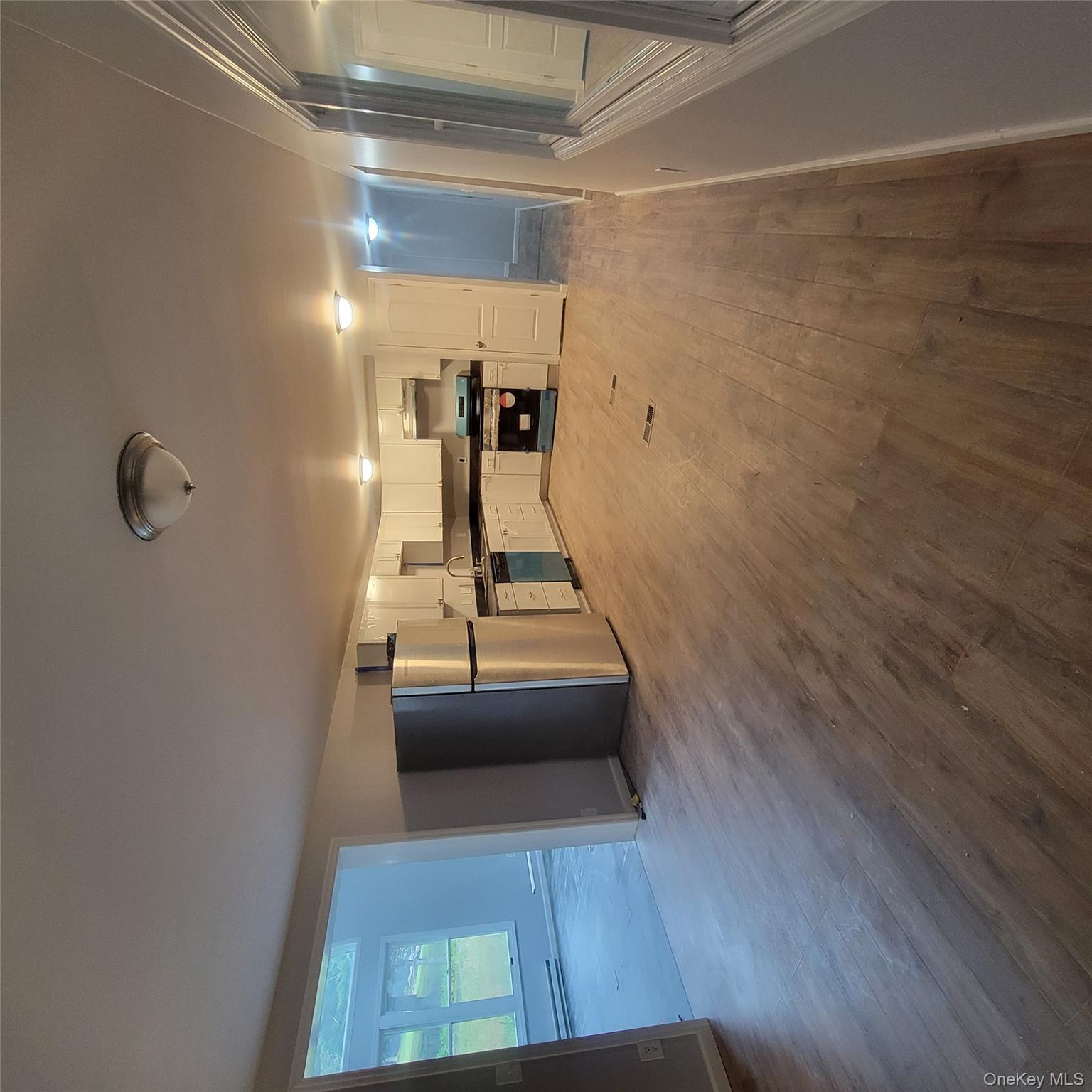 21 Browns Road Livingston Manor, NY 12758 - Photo 12 of 28 a view of a electric appliances in kitchen and empty room with wooden floor