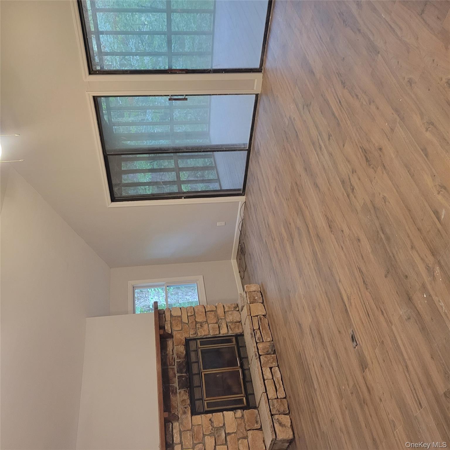 21 Browns Road Livingston Manor, NY 12758 - Photo 14 of 28 an empty room with wooden floor and fireplace