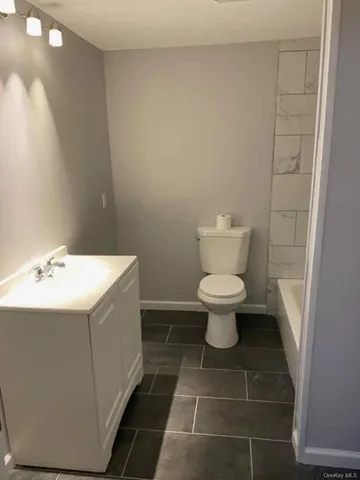 a view of a room with wooden floor and a window