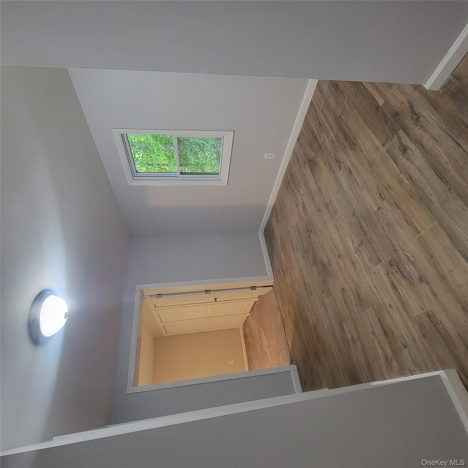 21 Browns Road Livingston Manor, NY 12758 - Photo 8 of 28 an empty room with wooden floor and windows