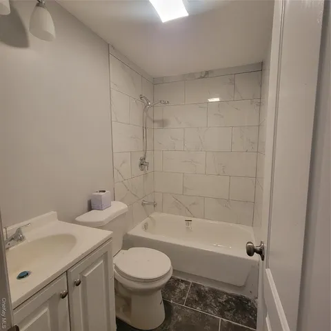a kitchen with granite countertop a stove top oven sink and cabinets