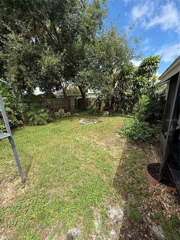 a backyard of a house with table and chairs