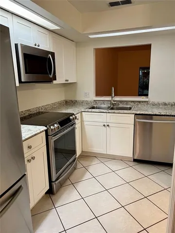 a kitchen with a sink and refrigerator