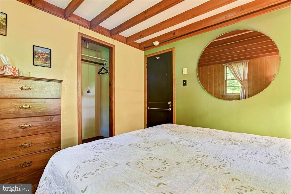 112 Beechwood Cove Road Greentown, PA 18426 - Photo 15 of 59 a bedroom with a bed and a mirror