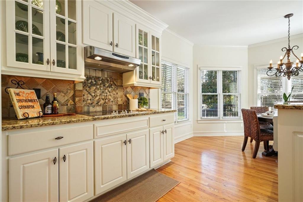 1260 Elk Ridge Cove Alpharetta, GA 30005 - Photo 19 of 87 a kitchen with cabinets and wooden floor