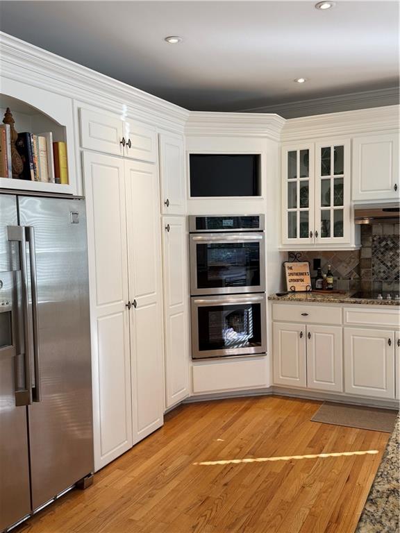 1260 Elk Ridge Cove Alpharetta, GA 30005 - Photo 20 of 87 a view of a kitchen with stainless steel appliances kitchen island granite countertop a refrigerator and a stove top oven