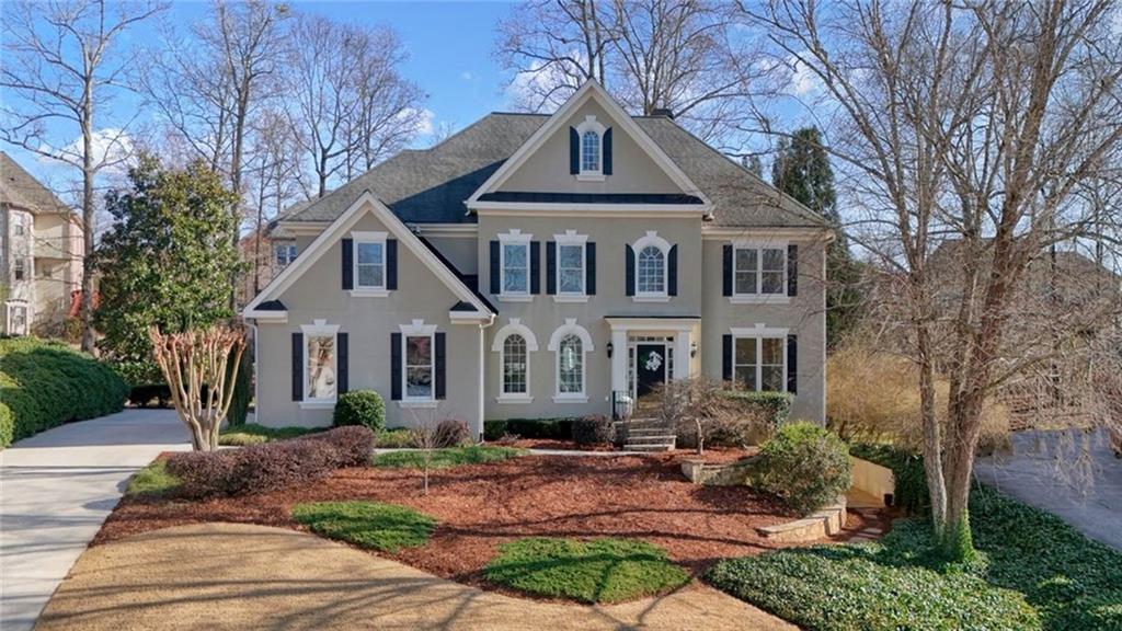 1260 Elk Ridge Cove Alpharetta, GA 30005 - Photo 2 of 87 a front view of a house with garden