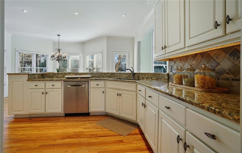 1260 Elk Ridge Cove Alpharetta, GA 30005 - Photo 22 of 87 a kitchen with stainless steel appliances granite countertop a sink and cabinets