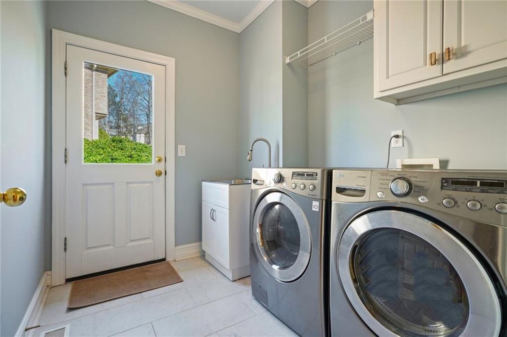 1260 Elk Ridge Cove Alpharetta, GA 30005 - Photo 24 of 87 a utility room with dryer and washer