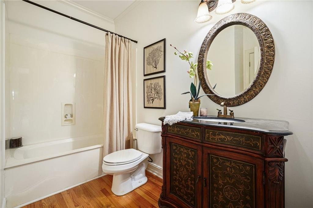 1260 Elk Ridge Cove Alpharetta, GA 30005 - Photo 27 of 87 a bathroom with a toilet a sink and a mirror