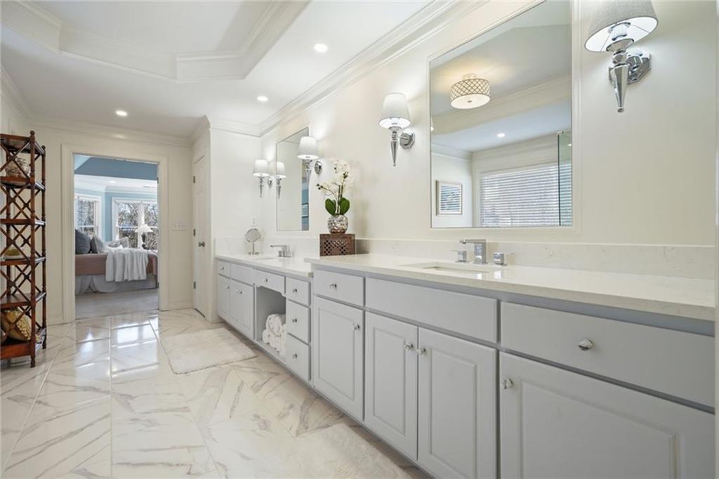 1260 Elk Ridge Cove Alpharetta, GA 30005 - Photo 38 of 87 a spacious bathroom with a double vanity sink a mirror and a shower