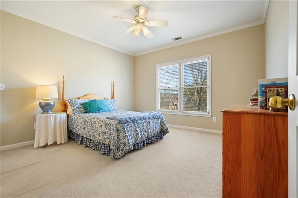 1260 Elk Ridge Cove Alpharetta, GA 30005 - Photo 39 of 87 a living room with a bed furniture and a window