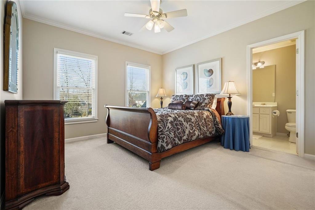 1260 Elk Ridge Cove Alpharetta, GA 30005 - Photo 45 of 87 a bedroom with a bed and a chandelier