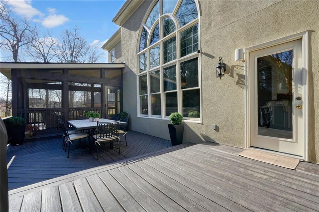 1260 Elk Ridge Cove Alpharetta, GA 30005 - Photo 57 of 87 a backyard of a house with barbeque oven table and chairs