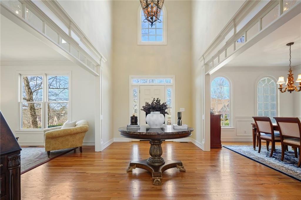 1260 Elk Ridge Cove Alpharetta, GA 30005 - Photo 6 of 87 a living room with fireplace furniture and a wooden floor