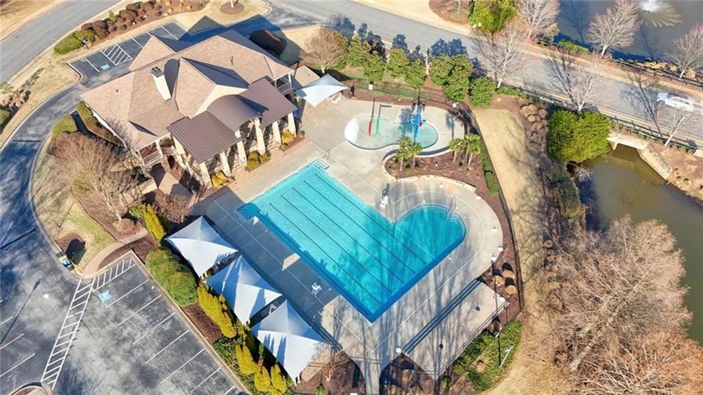 1260 Elk Ridge Cove Alpharetta, GA 30005 - Photo 79 of 87 a view of swimming pool with outdoor seating and plants